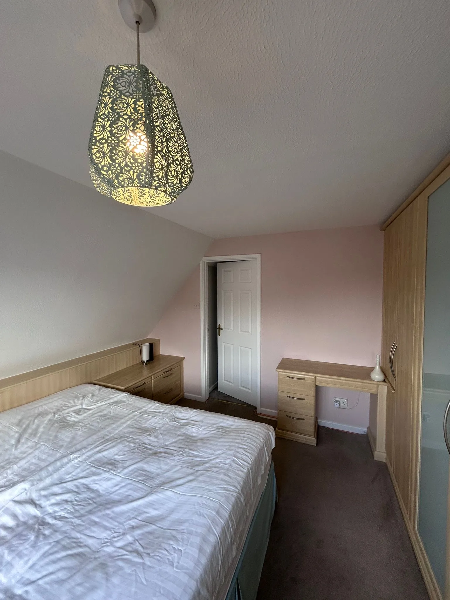 Redecorated bedroom in Ashby-de-la-Zouch with freshly painted walls and a ceiling light