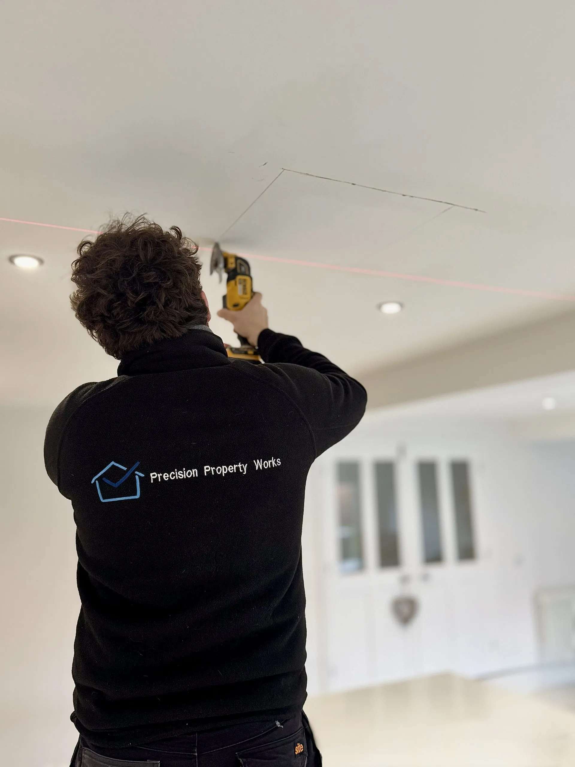 Emergency plumbing repair being carried out overhead