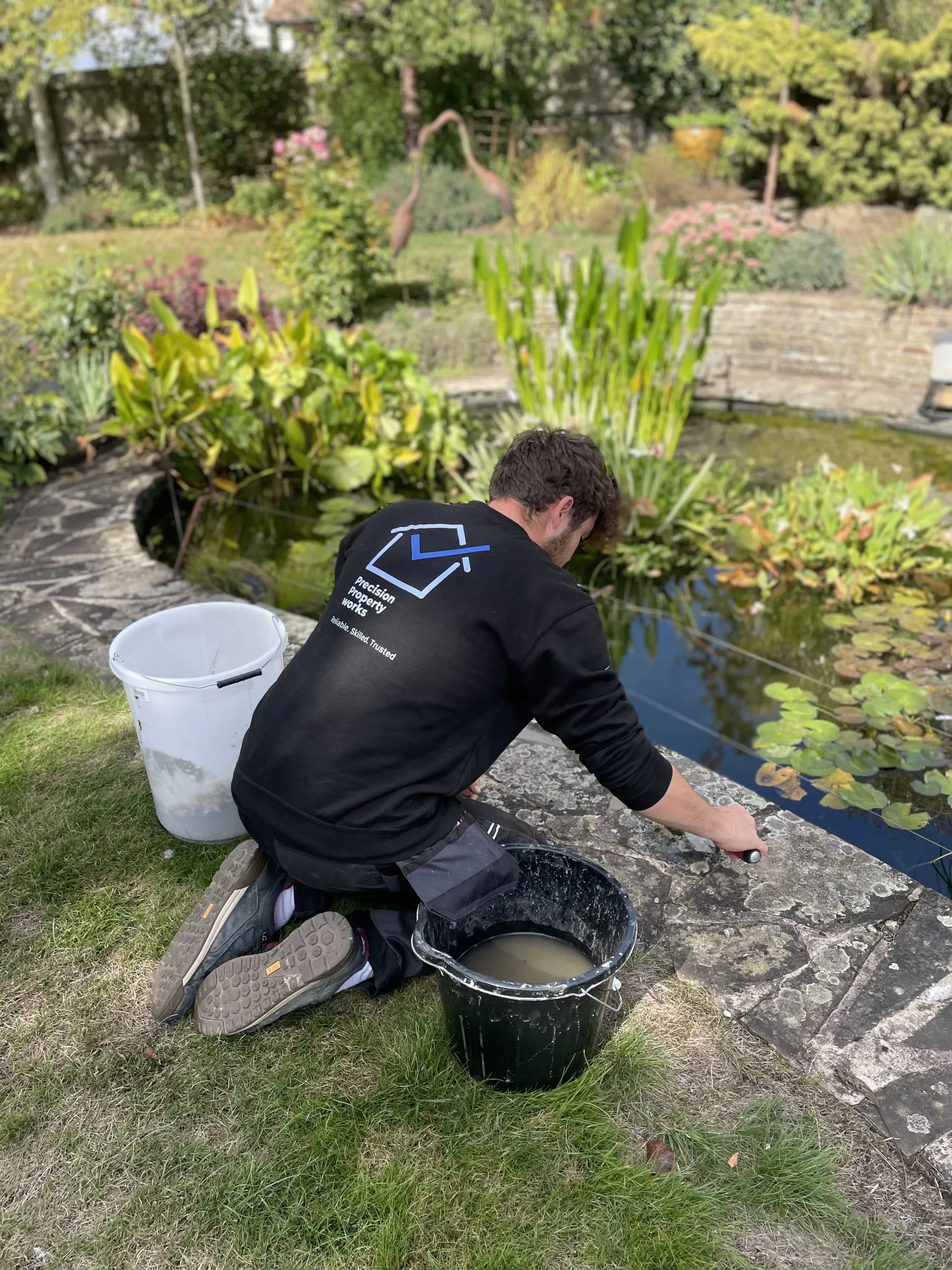 Repointing crazy paving by hand, filling the joints between the stones