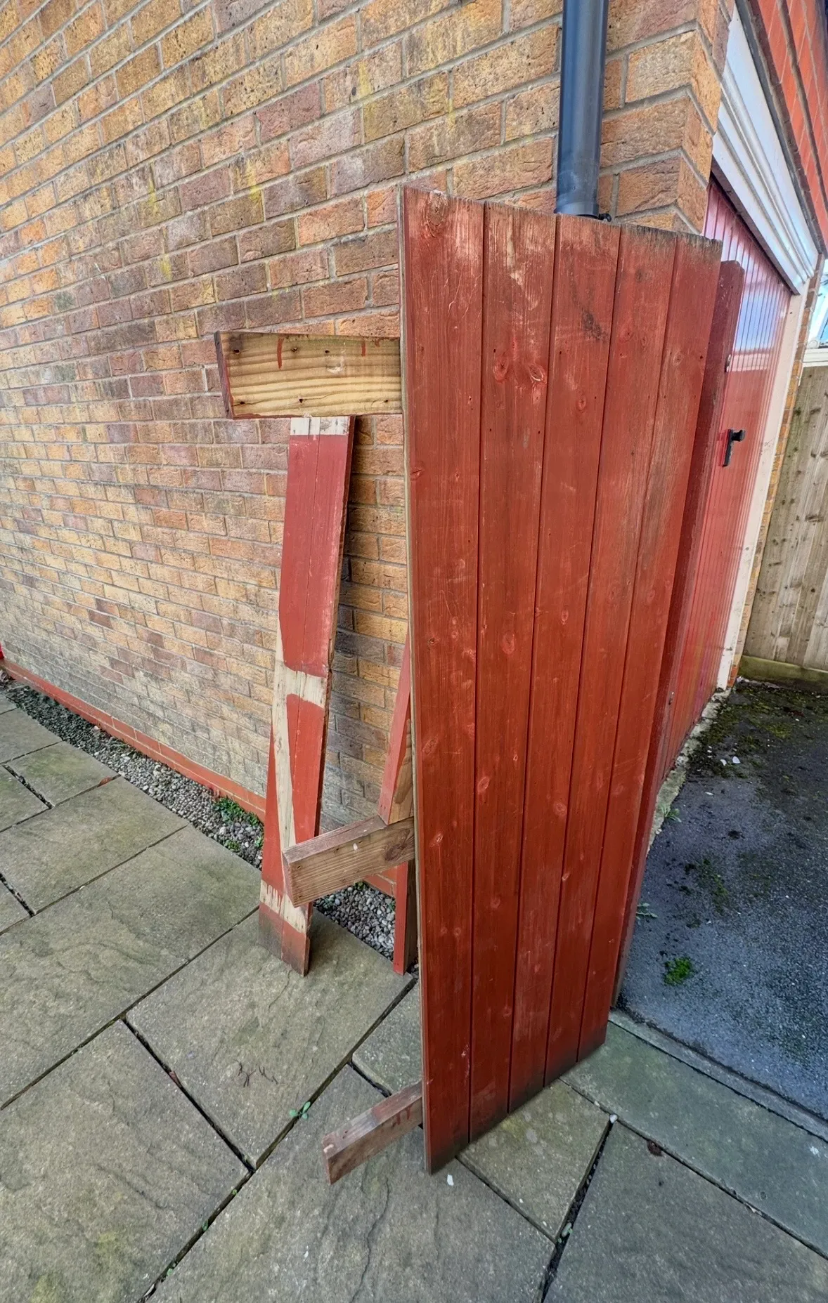 Storm damaged garden gate after repair, repainted