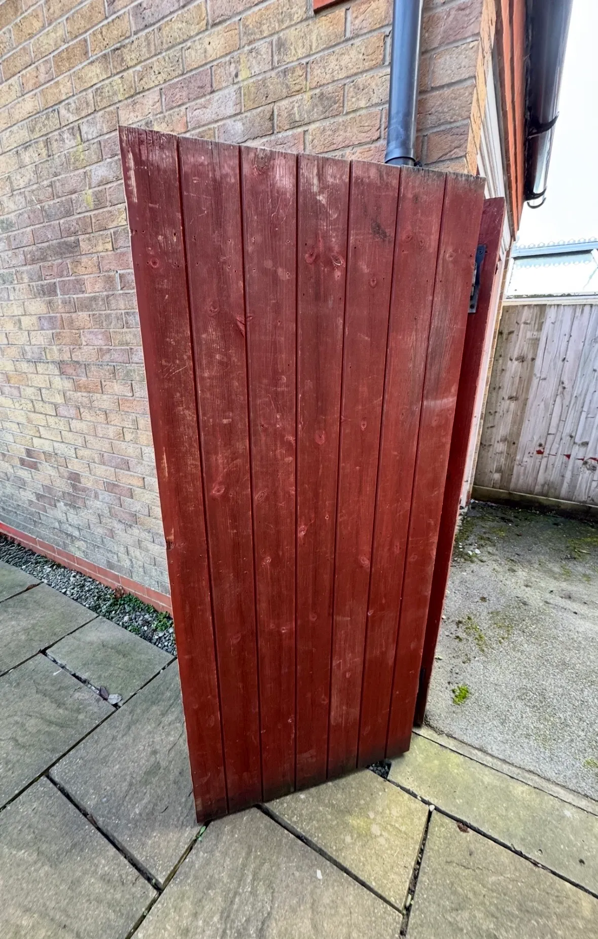 Repaired garden gate closed and rehung, with no replacement needed