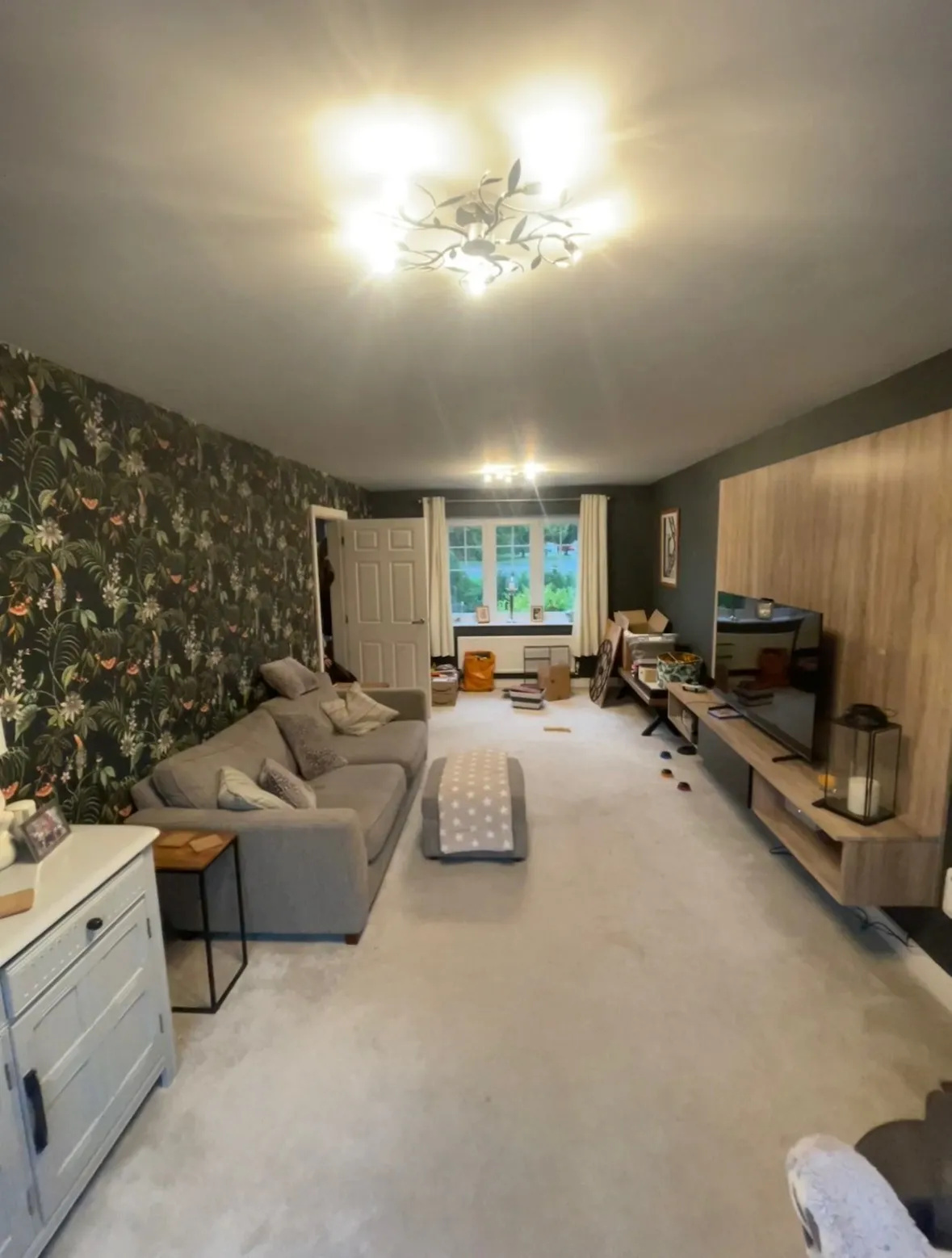 Living room in Ibstock part-way through renovation, with dust sheets down