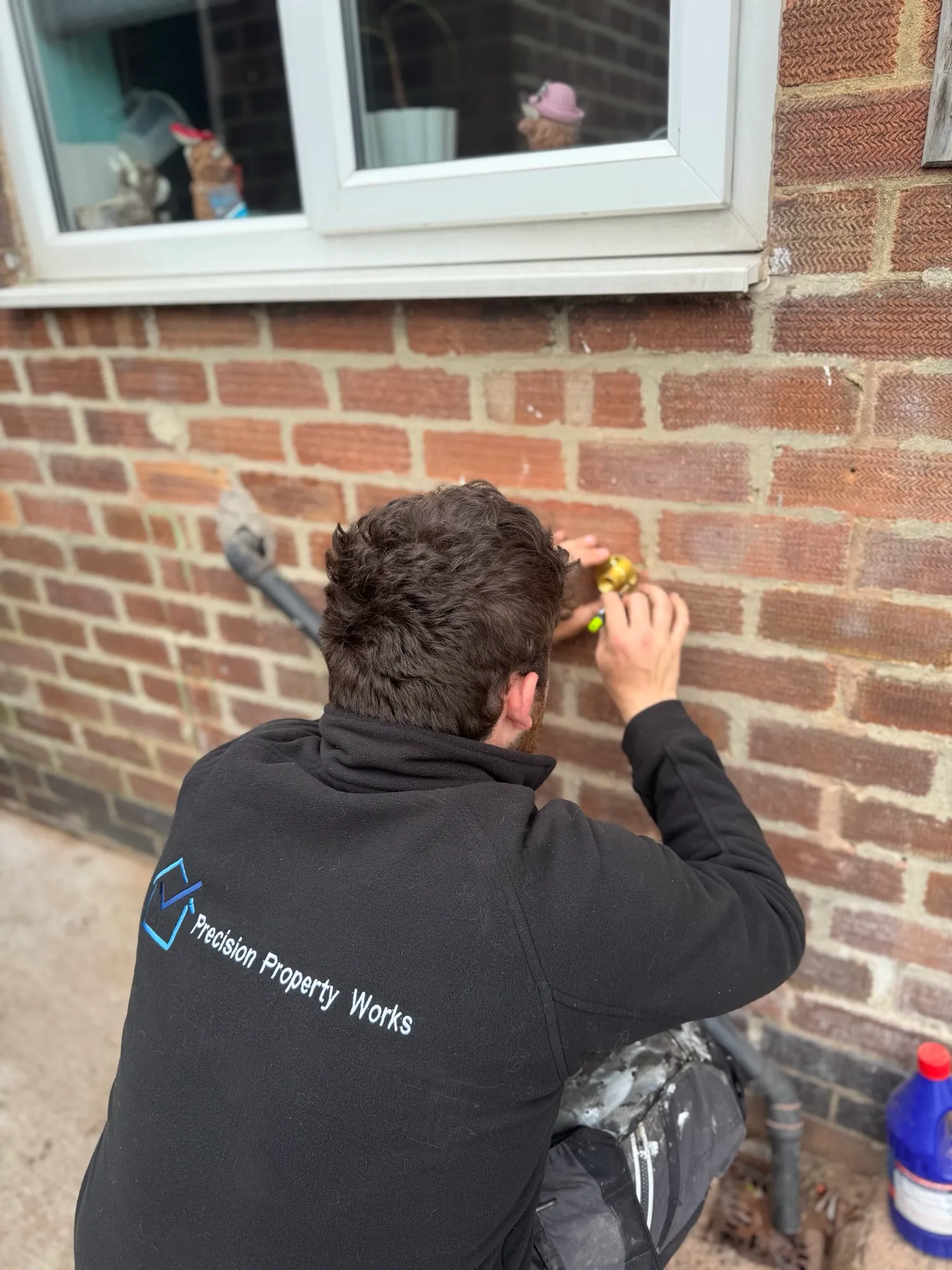 Drilling through an exterior brick wall to install an outdoor tap