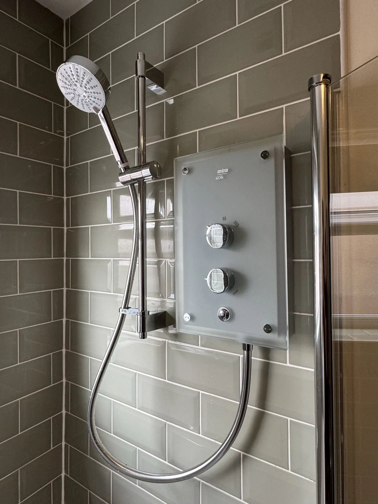Mira Azora frosted glass electric shower fitted to a tiled bathroom wall